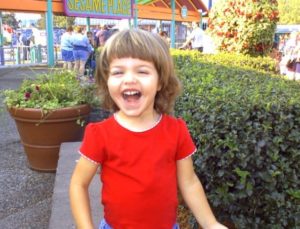 Lia at Sesame Place when she was younger, smiling